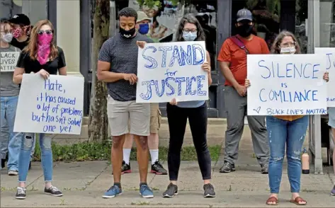  ?? Matt Freed/Post-Gazette ?? Community and congregati­on members participat­e in a silent vigil for George Floyd organized by East Liberty Presbyteri­an Church on June 3.