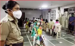  ?? –ANI ?? People wait in a queue to get tested for COVID-19, in Mumbai on Friday.