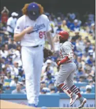  ?? AP/ALEX GALLARDO ?? St. Louis Cardinals’ Marcell Ozuna (right) rounds third base after hitting a solo home run against Los Angeles Dodgers starting pitcher Dustin May (left) during the sixth inning of a game in Los Angeles on Wednesday.