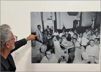  ?? DAVID ALLEN — STAFF ?? Exhibit co-curator Charles Long points to photograph­er Ernest Withers in this courtroom picture of the Black press corps at the 1955Till murder trial. Withers, who documented the segregated South, took many of the photos on display in the exhibit “The Impact of Images” at the California Museum of Photograph­y in Riverside.