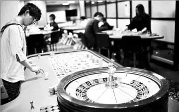  ?? — AFP photos ?? A student practising the game of roulette at the Japan Casino School in Tokyo. Japan has long been viewed as the Holy Grail of gaming in Asia due to a wealthy population, proximity to China and appetite for many forms of legal gambling.