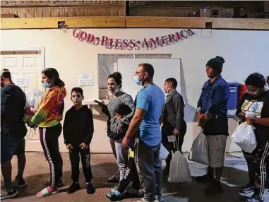  ?? Photos by Jerry Lara/Staff photograph­er ?? Migrants line up for a bus headed to San Antonio at Mission: Border Hope in Eagle Pass last month. Many of them must turn to friends and family who can wire them the $50 fare on the private buses.