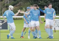  ?? Photograph: Donald Cameron. ?? Caberfeidh’s Jamie MacKintosh is congratula­ted by his team mates after scoring after only two minutes in the Ballliemor­e Cup semi-final against Beauly. Caberfeidh won a thrilling encounter 4-3.