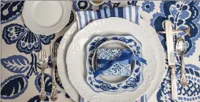  ??  ?? The place settings are super simple: everyday white plates topped with a sweet blue and white salad plate. (Mary Carol Garrity)