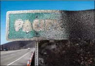  ?? The New York Times/STUART PALLEY ?? This road sign seen Wednesday on the Pacific Coast Highway in Malibu, Calif., was melted by the Woolsey Fire.