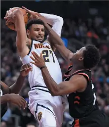  ?? THE CANADIAN PRESS/NATHAN DENETTE ?? Toronto Raptors guard Kyle Lowry (7) pressures Denver Nuggets guard Jamal Murray (27) during second half NBA action in Toronto on Monday.