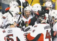  ?? Michael Dwyer / Associated Press ?? Ottawa’s Clarke MacArthur is at the center of the action after scoring the series clincher in overtime.