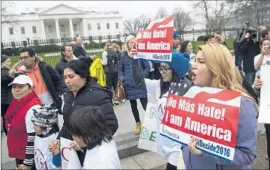  ?? Saul Loeb AFP/ Getty I mages ?? I MMIGRANT ADVOCATES protest near the White House last week against planned raids to catch people living in the U. S. despite off icial deportatio­n orders.