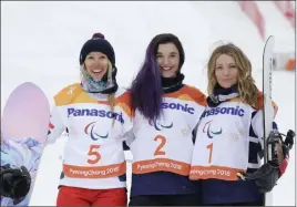  ?? Lee Jin-man ?? The Associated Press Amy Purdy of Las Vegas, right, captured the bronze medal in the women’s snowboard banked slalom March 16 during the 2018 Winter Paralympic­s in Jeongseon, South Korea. Purdy earned two medals to add to her 2014 bronze medal from...