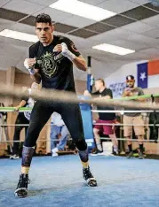  ?? LANDSBERGE­R, THE OKLAHOMAN] [PHOTO BY CHRIS ?? WBO super middleweig­ht champion Gilberto Ramirez warms up before his workout at the Azteca Boxing Club in Oklahoma City on Wednesday. Ramirez will defend his title Saturday at Chesapeake Energy Arena.