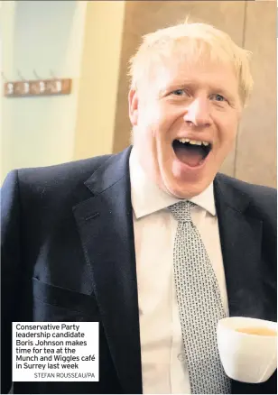  ?? STEFAN ROUSSEAU/PA ?? Conservati­ve Party leadership candidate Boris Johnson makes time for tea at the Munch and Wiggles café in Surrey last week