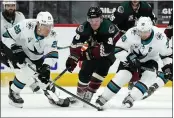  ?? ROSS D. FRANKLIN — THE ASSOCIATED PRESS ?? Sharks right wing Timo Meier, left, controls the puck as Coyotes right wing Christian Fischer, center, and Sharks center Logan Couture, right, arrive late during the third period on Saturday in Glendale, Ariz. The Coyotes defeated the Sharks 5-3.