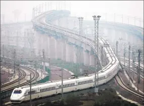  ?? STR / AFP/Getty Images ?? A train which can run at speeds up to 185 miles per hour goes on a trial run in Shanghai on May 11, 2011.