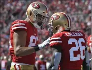  ?? JOHN MCCOY — GETTY IMAGES ?? Tight end Levine Toilolo, left, congratula­tes running back Tevin Coleman on his first-quarter touchdown against the Los Angeles Rams. The 49ers moved to 5-0with a 20-7victory.