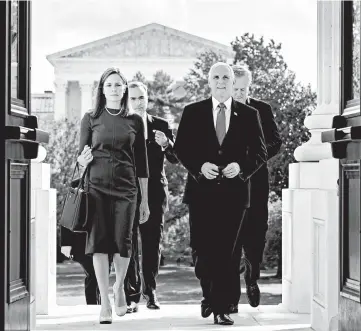  ?? ERIN SCHAFF/THE NEW YORK TIMES ?? With the Supreme Court in the background, Amy Coney Barrett and Vice President Mike Pence enter the Capitol on Tuesday.