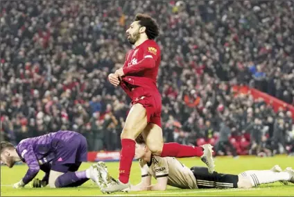  ?? AP PHOTO/JON SUPER ?? Liverpool’s Mohamed Salah (centre) celebrates after scoring his side’s second goal during the English Premier League soccer match between Liverpool and Manchester United at Anfield Stadium in Liverpool, on Sunday.