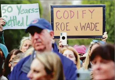  ?? Christian Abraham / Hearst Connecticu­t Media ?? People hold up protest signs as they join dozens of area residents taking part in a pro-choice rally in front of the Norwalk Courthouse in downtown Norwalk on Tuesday.