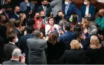  ?? Tom Brenner / New York Times ?? House Democrats surround Speaker Nancy Pelosi after the passage of the legislatio­n, which faces uncertaint­y in the Senate.