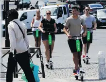  ?? FRANCOIS GUILLOT/AFP/GETTY IMAGES ?? California-based Lime hopes its e-scooters will help reduce congestion and carbon emissions.