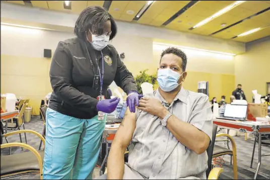  ?? John Archiquett­e VA Public Affairs ?? Ronald Pipkins’ story garnered statewide attention after his recovery, and he later worked with Gov. Steve Sisolak on public service announceme­nts about the seriousnes­s of the disease. On Wednesday, he got the first dose of the COVID-19 vaccine.