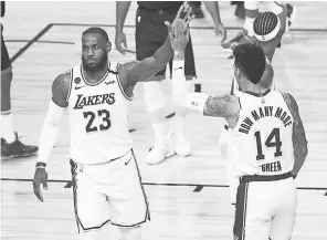  ?? KIM KLEMENT/ USA TODAY SPORTS ?? LeBron James ( 23) and Danny Green ( 14) celebrate the Lakers’ series- clinching win Saturday against the Rockets.