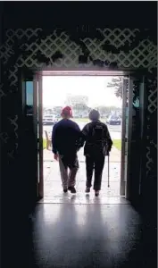  ?? Bryan Chan Los Angeles Times ?? A MOTHER and her son walk out of the Fairview Developmen­tal Center, a state facility in Costa Mesa.