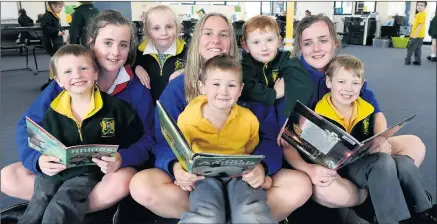  ?? Picture: PAUL CARRACHER ?? SUPPORT: Ararat West Primary School students have relocated to Ararat College after fire destroyed a wing at the primary school at the weekend. Pictured reading together during the temporary arrangemen­t are Ararat West pupils and Ararat College year-10...