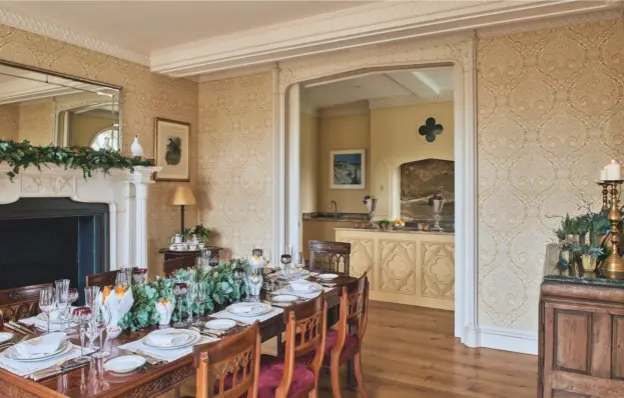  ??  ?? DINING ROOM AND KITCHEN
Sliding doors (below) were installed to divide the two rooms, which now occupy what was originally the North Wing’s lobby. The ornate columns and cornices were carefully recreated using moulds made from the remains of the...