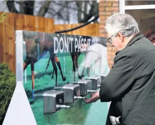  ?? Picture: PA ?? Racegoers using hand sanitiser dispensers