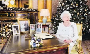  ?? PHOTO: REUTERS ?? Christmas cheer . . . Queen Elizabeth sits at a desk in the 1844 Room after recording her Christmas Day broadcast to the Commonweal­th last year.