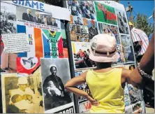  ?? Picture: ALAISTER RUSSELL ?? WALL OF REMEMBRANC­E: Visitors look at an exhibition highlighti­ng historic sacrifices around South Africa, struggle heroes and historic sights on Human Rights Day in Sharpevill­e yesterday, and to reflect on the March 21 1960 massacre