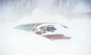  ?? JOSEPH COOKE/BUFFALO NEWS ?? The December 2022 Buffalo blizzard kept city residents stranded at home for several days. Numerous vehicles wound up buried in snow on local streets.