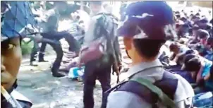  ?? TIM WARNER/GETTY IMAGES/AFP ?? This screen grab taken on January 4 from a YouTube video originally taken by Myanmar Constable Zaw Myo Htike (pictured at far left) shows a policeman (back left) kicking a Rohingya villager, in the village of Kotankauk on November 5, 2016.