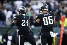  ?? MATT ROURKE – THE ASSOCIATED PRESS ?? Eagles running back Jordan Howard, left, and tight end Zach Ertz celebrate a touchdown in the third quarter against the Bears Sunday at Lincoln Financial Field.