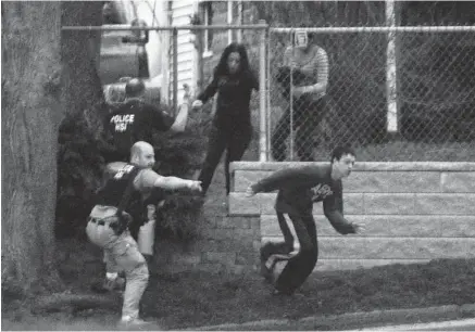  ?? DARREN MCCOLLESTE­R/GETTY IMAGES ?? Police help residents flee from a residentia­l area where Dzhokhar Tsarnaev, a suspect in the Boston Marathon bombings, was hiding in Watertown.