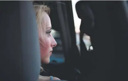  ?? Joe Amon, The Denver Post ?? Sarah Janeczko, 20, with her boyfriend Anthony “Panda” Howard-martinez (not pictured), looks out at cars parked along Federal Boulevard on May 5 in Denver.