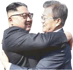  ?? AP ?? North Korean leader Kim Jong-un hugs South Korean President Moon Jae-in after their meeting at the northern side of Panmunjom on Saturday.