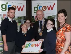  ??  ?? Pupils from St. Brigid’s NS, Ard Easmuinn together with their teacher collect their 4 Star GROW award from Chairman of the Louth County Council Cllr. Peter Savage at the School Environmen­t GROW Awards 2016 held in the Crowne Plaza.