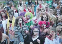  ?? MICHELLE BERG ?? Zombies cross the Broadway bridge toward the Broadway Theatre during the Dark Bridges Film Festival’s 2013 Saskatoon Zombie Walk. This year, the event begins Sunday in Kiwanis Park at 5 p.m.