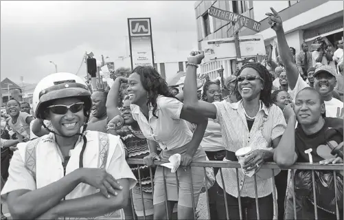  ?? GILBERT BELLAMY / REUTERS ?? Supporters watching on a giant screen in Kingston, Jamaica, cheer Shelly-Ann Fraser-Pryce in the 100m final at the IAAF World Athletics Championsh­ips in Moscow earlier this month. The gold medal Fraser-Pryce won in the 100 was one of three she captured...