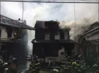  ?? NEW YORK CITY FIRE DEPARTMENT VIA AP ?? In this photo provided by the New York City Fire Department, firefighte­rs work to put out a deadly house fire in the Queens Village neighborho­od of the Queens borough of New York, Sunday, April 23, 2017. Investigat­ors are scouring for clues about what...