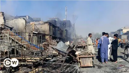  ??  ?? Afghans inspect damaged shops after fighting between Taliban and Afghan security forces in Kunduz city