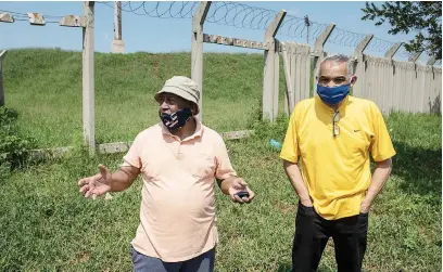  ?? Picture: Michel Bega ?? DEAR MR MAYOR. Ennerdale residents Elmer Leray, left, and David Lucas at a vandalised section of a wall at a stadium yesterday. Residents are concerned about the state of infrastruc­ture in the area.