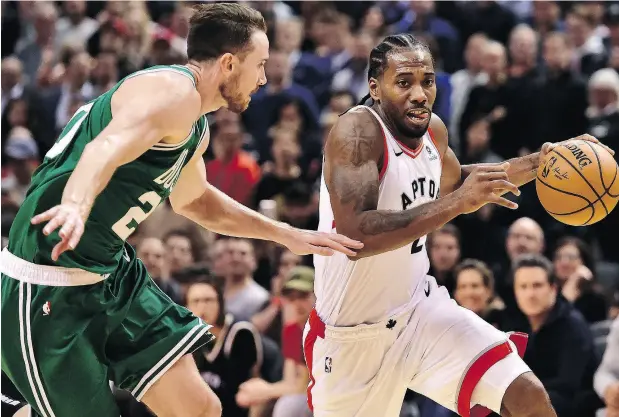  ?? FRANK GUNN / THE CANADIAN PRESS ?? Toronto Raptors forward Kawhi Leonard moves around Boston Celtics forward Gordon Hayward during NBA action in Toronto on Friday. Leonard appears to have found his stroke again after missing most of last season.