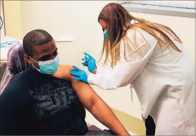  ?? Samuel Diaz / Southwest Community Health Center / Contribute­d photo ?? Carmen Rivera-Torres, chief nursing officer at Southwest Community Health Center, delivers the first doses of the Moderna COVID-19 vaccine to front-line staff on Wednesday.