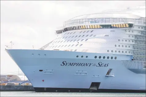  ?? Wilfredo Lee / Associated Press ?? The Symphony of the Seas cruise ship is shown docked May 20 in Miami. Royal Caribbean Cruises Ltd. recently reported a first-quarter loss of $1.44 billion, after reporting a profit in the same period a year earlier.