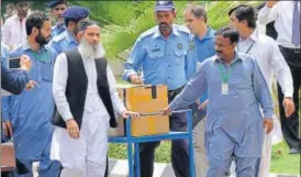  ?? AFP ?? Officials transport a box of final evidence presented by the Joint Investigat­ion Team.