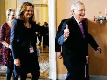  ?? DREW ANGERER / GETTY IMAGES ?? LEFT: Senate Majority Leader Mitch McConnell, R-Ky., makes the thumbs-up sign as he leaves the Senate floor after reaching an agreement to advance a bill ending the government shutdown on Monday. JACQUELYN MARTIN / AP RIGHT: Senate Minority Leader...