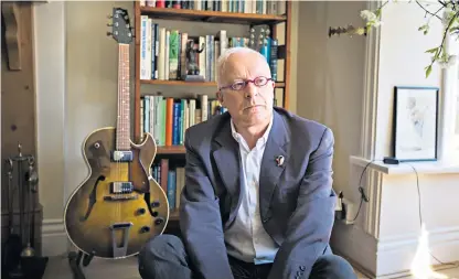  ??  ?? Phil Shiner, right, in his Birmingham home with one of his limited-edition guitars. He was paid millions after bringing cases against veterans