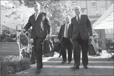  ?? AP Photo/Jacquelyn Martin ?? Closing arguments: Members of the defense team for Paul Manafort, from left, Kevin Downing, Richard Westling, and Thomas Zehnle, walk to federal court for closing arguments in the trial of the former Trump campaign chairman, in Alexandria, Va., Wednesday.